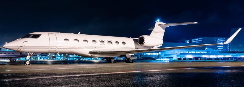 empty leg charter flights jet parked at night